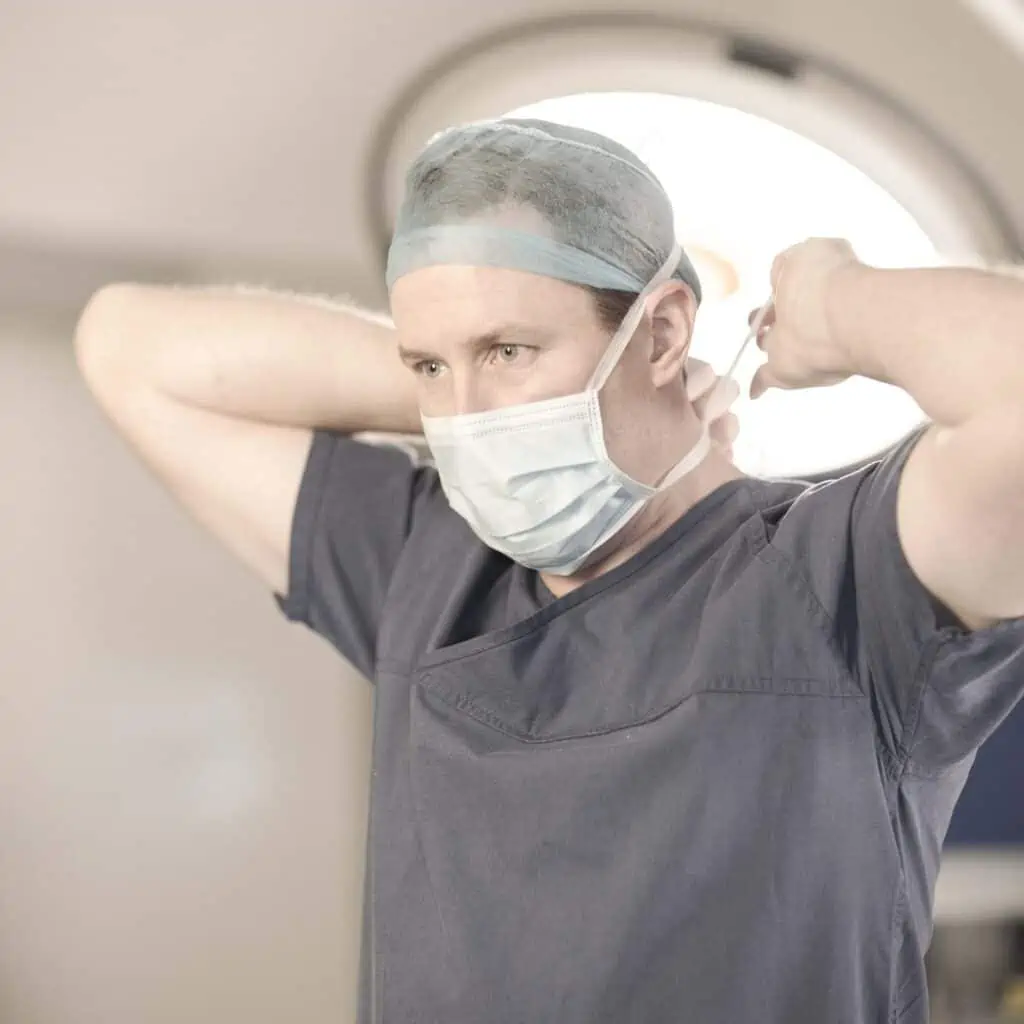 Dr Ben Lancashire securing his mask ready for surgery